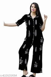 Black cotton nightsuit set for women, featuring printed kaftan and pyjamas with elastic waist, ideal for sleepwear and loungewear. Soft satin fabric ensures comfort and style for all seasons. Indian origin